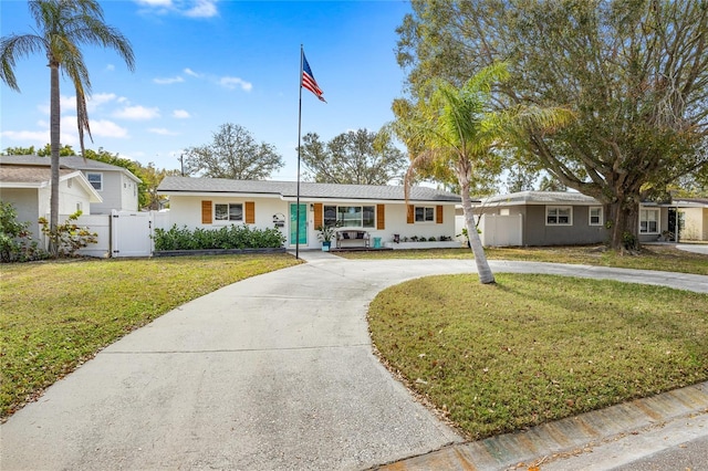 ranch-style home featuring a front yard