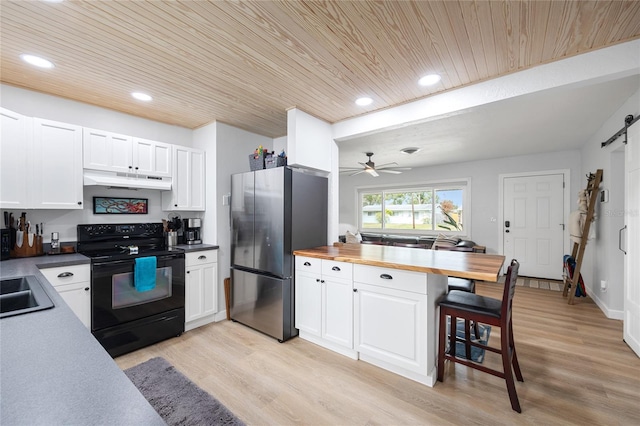 kitchen featuring ceiling fan, a barn door, stainless steel refrigerator, black / electric stove, and wooden ceiling