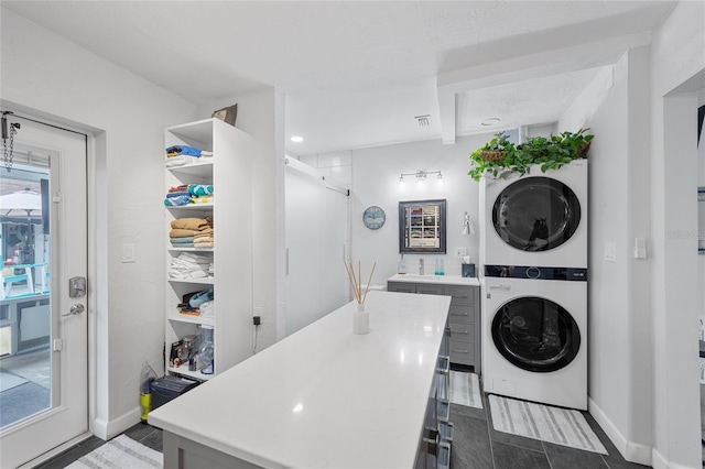 laundry area with stacked washing maching and dryer