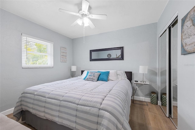 bedroom with ceiling fan, hardwood / wood-style floors, and a closet