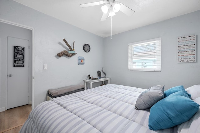 bedroom with ceiling fan and light hardwood / wood-style flooring