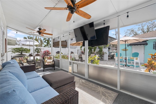 sunroom featuring ceiling fan