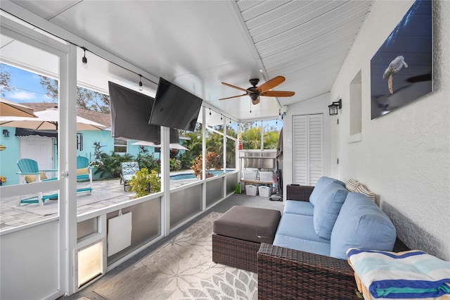 sunroom featuring ceiling fan and lofted ceiling