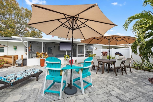 view of patio with a sunroom