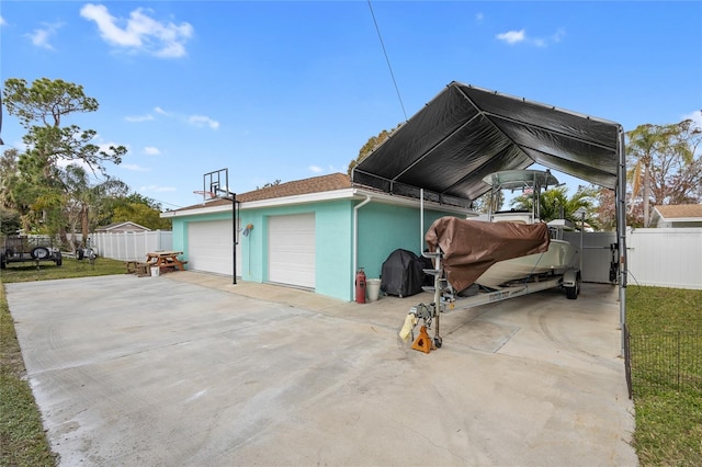 view of side of home featuring a garage and a carport