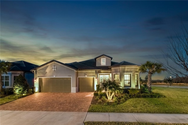 view of front of home featuring a yard and a garage