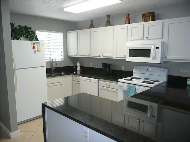 kitchen featuring white cabinetry, sink, and white appliances