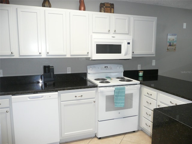 kitchen featuring light tile patterned floors, white appliances, and white cabinetry