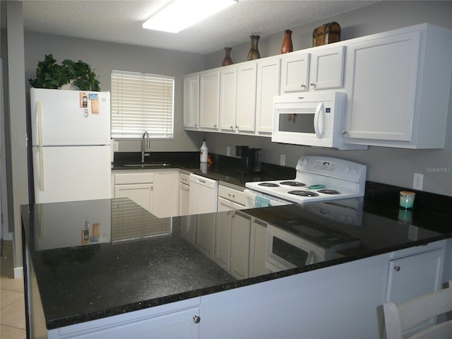 kitchen featuring light tile patterned floors, white cabinetry, white appliances, a textured ceiling, and sink