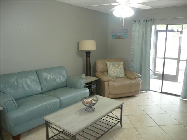 living room with ceiling fan and light tile patterned floors