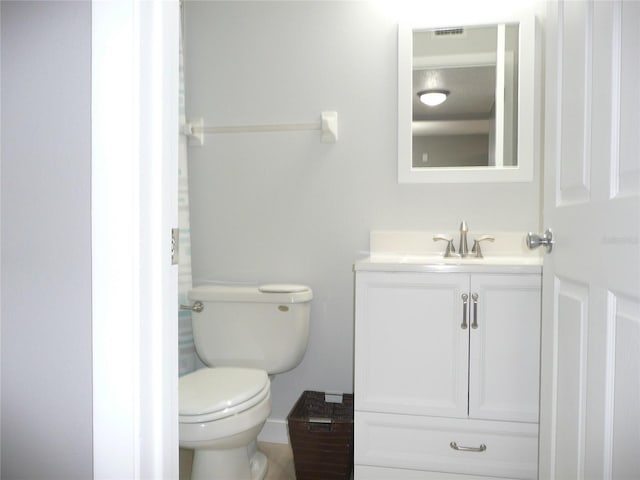 bathroom featuring toilet and vanity