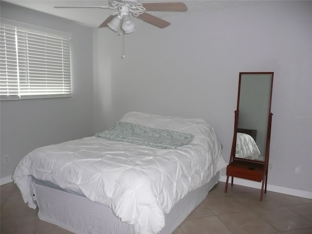 bedroom featuring ceiling fan and tile patterned flooring