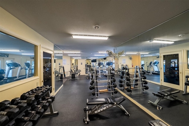 exercise room featuring a textured ceiling