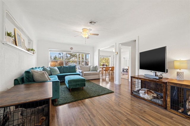 living room featuring ceiling fan and wood-type flooring