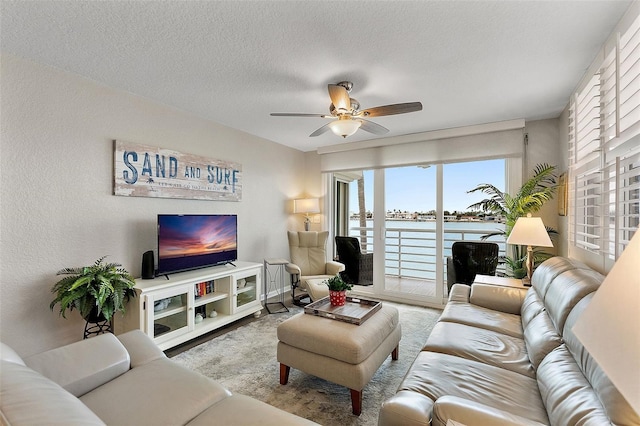 living room featuring light carpet, a textured ceiling, and ceiling fan