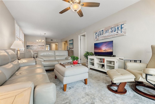 living room featuring ceiling fan with notable chandelier and light carpet