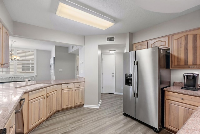 kitchen with pendant lighting, sink, appliances with stainless steel finishes, a chandelier, and light brown cabinets