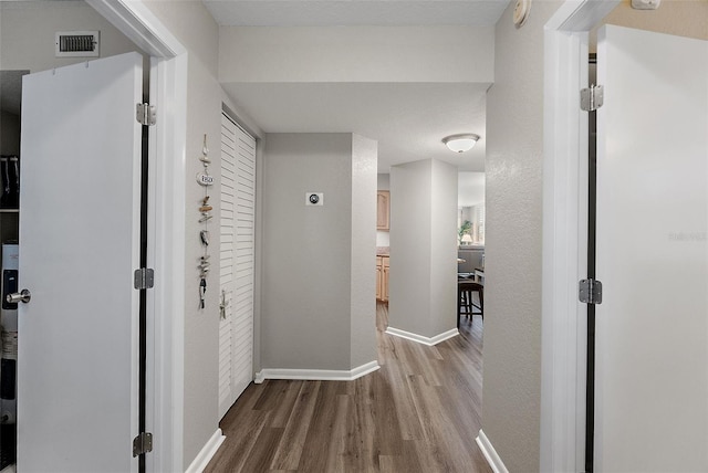 corridor with wood-type flooring