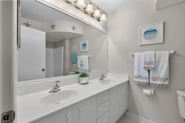 bathroom featuring walk in shower, tile patterned floors, toilet, and vanity