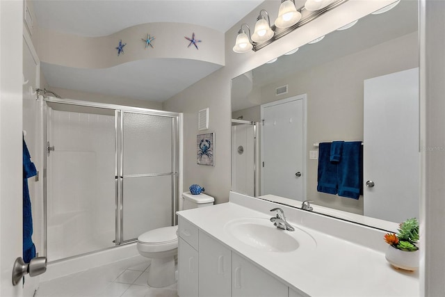 bathroom featuring a shower with door, vanity, tile patterned floors, and toilet