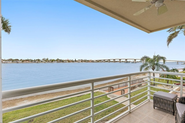 balcony with a water view and ceiling fan