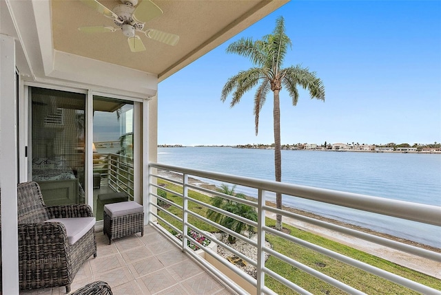 balcony with a water view and ceiling fan