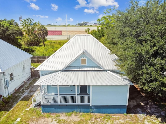 back of property featuring covered porch