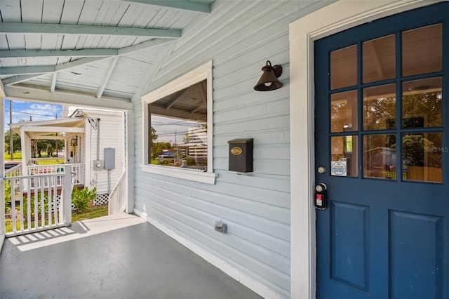 view of exterior entry with a porch