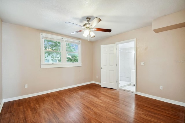 empty room featuring ceiling fan, hardwood / wood-style floors, and a textured ceiling