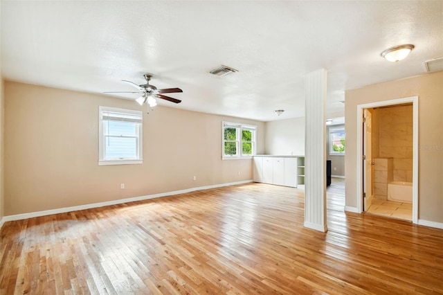 unfurnished room with light wood-type flooring and ceiling fan