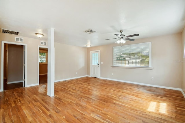 unfurnished living room with light wood-type flooring, ceiling fan, and a healthy amount of sunlight