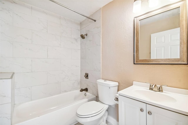 full bathroom featuring toilet, vanity, and tiled shower / bath