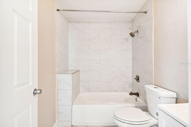 full bathroom featuring toilet, vanity, and tiled shower / bath combo