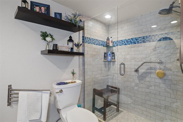 bathroom featuring toilet and walk in shower