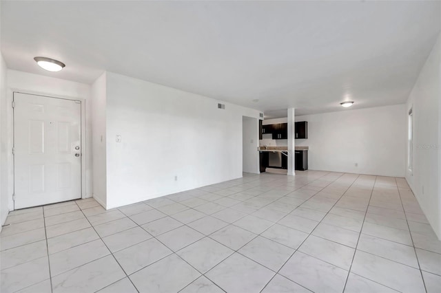 unfurnished living room featuring visible vents and light tile patterned floors