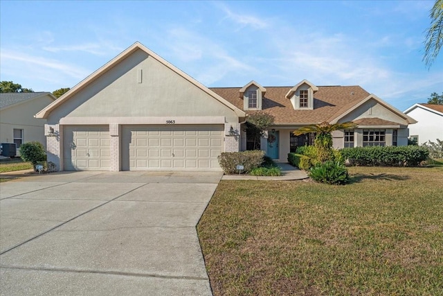 view of front of property featuring a front lawn, a garage, and central AC