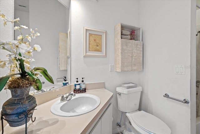 bathroom featuring toilet and vanity