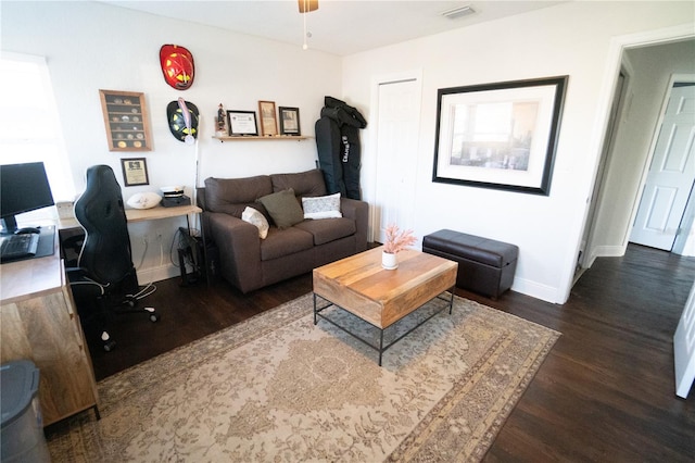 living room with ceiling fan and dark hardwood / wood-style flooring