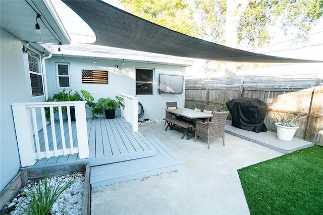 view of patio with grilling area and a wooden deck