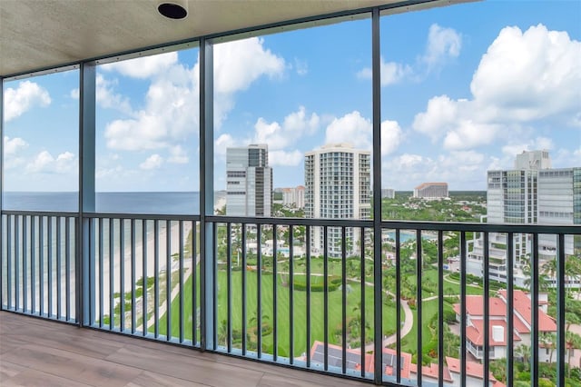 unfurnished sunroom featuring plenty of natural light and a water view