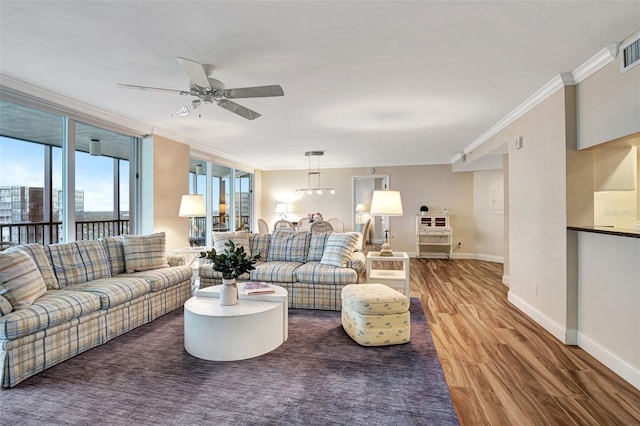 living room featuring ceiling fan, ornamental molding, and hardwood / wood-style floors