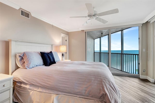 bedroom with light hardwood / wood-style floors, a water view, ceiling fan, ornamental molding, and access to exterior