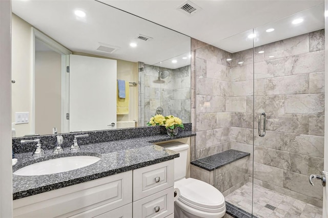 bathroom featuring toilet, walk in shower, and vanity