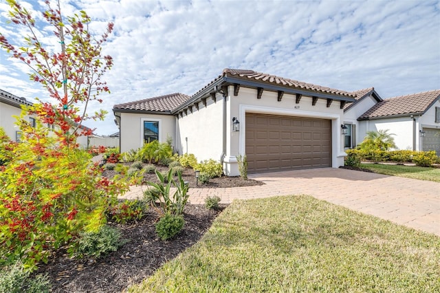 mediterranean / spanish-style home with a front lawn and a garage