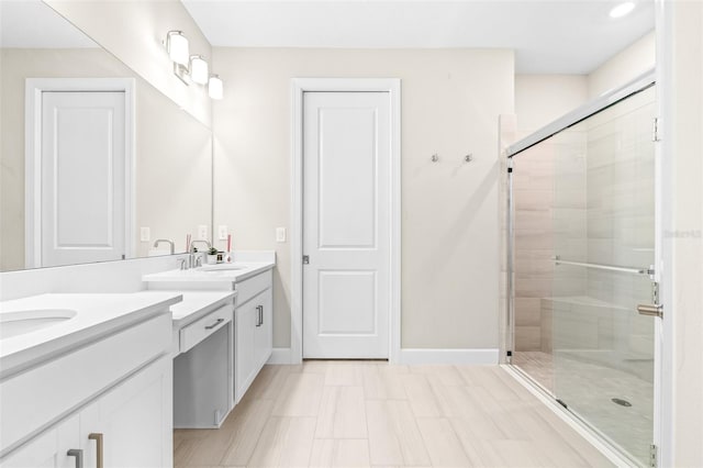 bathroom featuring walk in shower and vanity