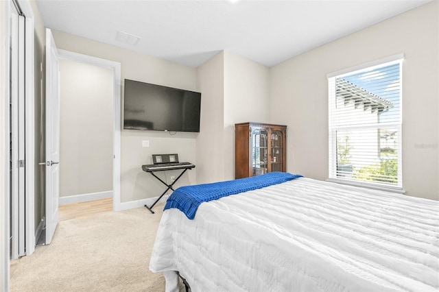 carpeted bedroom with a closet and multiple windows