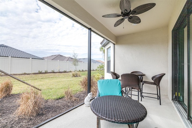 sunroom featuring ceiling fan