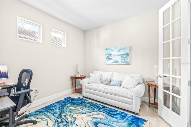 office with light hardwood / wood-style flooring and a textured ceiling