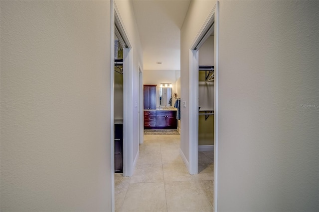 hallway with light tile patterned floors