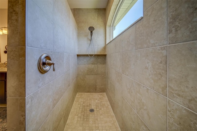 bathroom with a tile shower